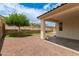 Backyard with stone and artificial turf and a covered porch area at 22040 N 119Th Dr, Sun City, AZ 85373