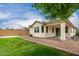 Spacious backyard featuring lush lawn, covered patio, perfect for outdoor relaxation and entertaining at 22040 N 119Th Dr, Sun City, AZ 85373