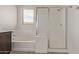 Bright bathroom showcases a soaking tub and a separate glass-enclosed shower with a showerhead at 22040 N 119Th Dr, Sun City, AZ 85373