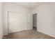 Carpeted bedroom features a closet with sliding doors at 22040 N 119Th Dr, Sun City, AZ 85373