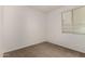 Carpeted bedroom features a window with blinds and neutral paint at 22040 N 119Th Dr, Sun City, AZ 85373
