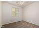 Bright bedroom features a ceiling fan and window with blinds at 22040 N 119Th Dr, Sun City, AZ 85373