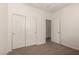 Carpeted bedroom features a closet with sliding doors at 22040 N 119Th Dr, Sun City, AZ 85373