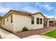 Home exterior featuring stucco walls, tile roof, and desert landscaping in a residential neighborhood at 22040 N 119Th Dr, Sun City, AZ 85373