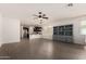 Open-concept living area featuring tile floors with views of the kitchen and backyard at 22040 N 119Th Dr, Sun City, AZ 85373
