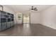 Expansive living room with tile floors, ceiling fan and sliding glass doors to backyard at 22040 N 119Th Dr, Sun City, AZ 85373