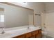 A well-lit bathroom is equipped with a double sink vanity and a shower-tub combo at 2210 N 27Th Pl, Phoenix, AZ 85008