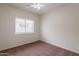 Bright bedroom features carpeted floors, large window and a ceiling fan at 2210 N 27Th Pl, Phoenix, AZ 85008
