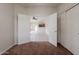 Bedroom featuring carpeted floors, closet doors, and view into a kitchen and living area at 2210 N 27Th Pl, Phoenix, AZ 85008