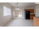 Well-lit dining area flows into kitchen with black refrigerator, tile floors, and backyard views at 2210 N 27Th Pl, Phoenix, AZ 85008