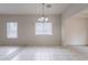 Dining room with tile floors, chandelier, and large windows providing natural light at 2210 N 27Th Pl, Phoenix, AZ 85008