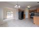 Open kitchen with black refrigerator, ample cabinets, tile floors, and access to backyard at 2210 N 27Th Pl, Phoenix, AZ 85008