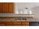Stainless steel kitchen sink with neutral countertops, cabinets, and open view to living area at 2210 N 27Th Pl, Phoenix, AZ 85008