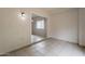 Spacious open room with light fixture, tiled flooring and light wall color at 2210 N 27Th Pl, Phoenix, AZ 85008