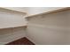 A walk-in closet features shelves and rods to maximize organization and storage at 2210 N 27Th Pl, Phoenix, AZ 85008