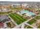 Beautiful aerial view of the community pool, amenity center, playground, and school at 23097 E Camina Buena Vis, Queen Creek, AZ 85142