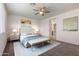 Bright bedroom featuring neutral decor, plush carpet, a ceiling fan, and a well-lit, relaxing space at 23097 E Camina Buena Vis, Queen Creek, AZ 85142