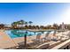 Community pool featuring lounge chairs, palm trees, and clear blue skies at 23097 E Camina Buena Vis, Queen Creek, AZ 85142