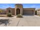 Charming home featuring a turret entrance and a two-car garage, complemented by well-maintained landscaping at 23097 E Camina Buena Vis, Queen Creek, AZ 85142