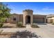 Inviting single-Gathering home with a unique turret entry, complemented by desert landscaping and a two-car garage at 23097 E Camina Buena Vis, Queen Creek, AZ 85142