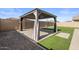 Backyard gazebo surrounded by gravel, turf, and brick pavers at 23097 E Camina Buena Vis, Queen Creek, AZ 85142