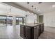 Kitchen island featuring granite countertop and stainless sink overlooking the living area and backyard at 23097 E Camina Buena Vis, Queen Creek, AZ 85142