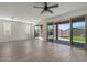 An inviting open-concept living room with tile floors and sliding glass doors to the backyard patio at 23097 E Camina Buena Vis, Queen Creek, AZ 85142