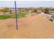 Community playground with climbing structures, swings, and play area with shade at 23097 E Camina Buena Vis, Queen Creek, AZ 85142