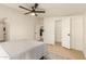 Bright bedroom featuring wood-look floors, ceiling fan, and an open closet, offering a serene retreat at 231 N 88Th Way, Mesa, AZ 85207