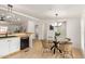 Bright dining area adjacent to the kitchen with a stylish chandelier and modern furniture at 231 N 88Th Way, Mesa, AZ 85207