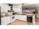 Well-lit kitchen with white cabinets, wood countertops, and modern appliances at 231 N 88Th Way, Mesa, AZ 85207