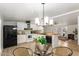 Modern kitchen with white cabinets, black appliances, and a seamless view to the living room at 231 N 88Th Way, Mesa, AZ 85207