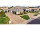 Expansive aerial view of a home with a circular driveway, a three-car garage, and manicured landscaping at 23465 S 202Nd St, Queen Creek, AZ 85142