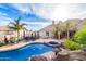Backyard features a lagoon style pool with a spa and waterfall feature at 23465 S 202Nd St, Queen Creek, AZ 85142