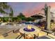 Backyard oasis with a pool, spa, waterfall feature, fire pit, and outdoor seating under a beautiful sunset at 23465 S 202Nd St, Queen Creek, AZ 85142