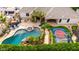 Aerial view of a stunning backyard with a pool, basketball court, outdoor kitchen, and lush landscaping at 23465 S 202Nd St, Queen Creek, AZ 85142