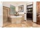 This bathroom features a soaking tub, a step in shower, and access to the closet at 23465 S 202Nd St, Queen Creek, AZ 85142