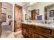 This bathroom features and sinks, granite counters and a wooden door at 23465 S 202Nd St, Queen Creek, AZ 85142
