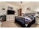 Spacious bedroom with stylish furnishings and a large screen TV for entertainment at 23465 S 202Nd St, Queen Creek, AZ 85142
