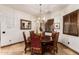 Charming dining room featuring a round table, stylish chandelier, and shuttered windows for cozy, natural light at 23465 S 202Nd St, Queen Creek, AZ 85142