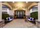 Elegant front entrance showcasing a grand chandelier, stone accents, and comfortable seating area at 23465 S 202Nd St, Queen Creek, AZ 85142