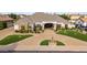 Elegant single-Gathering home featuring a brick driveway, manicured lawn, and welcoming entrance at 23465 S 202Nd St, Queen Creek, AZ 85142