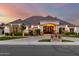 Stunning home featuring stone accents, manicured landscaping, and a grand entrance under a colorful sunset at 23465 S 202Nd St, Queen Creek, AZ 85142