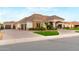 Charming home featuring an attached garage, manicured lawn, and a welcoming front entrance under a bright sky at 23465 S 202Nd St, Queen Creek, AZ 85142