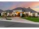 Beautiful home featuring manicured landscaping, a grand entrance, and tasteful exterior lighting at 23465 S 202Nd St, Queen Creek, AZ 85142