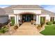 Inviting front entrance with a brick archway, elegant double doors, and meticulously maintained landscaping at 23465 S 202Nd St, Queen Creek, AZ 85142