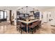 Open kitchen features an island bar, granite counters, stone details and stainless appliances at 23465 S 202Nd St, Queen Creek, AZ 85142