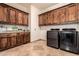 Functional laundry room featuring ample cabinetry, countertops, and modern appliances at 23465 S 202Nd St, Queen Creek, AZ 85142