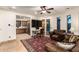 Cozy living room with a kitchen view, featuring comfortable seating and a stylish rug at 23465 S 202Nd St, Queen Creek, AZ 85142