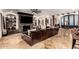 Living room featuring a stone fireplace, media built-ins, wood beams, and marble tile floors at 23465 S 202Nd St, Queen Creek, AZ 85142